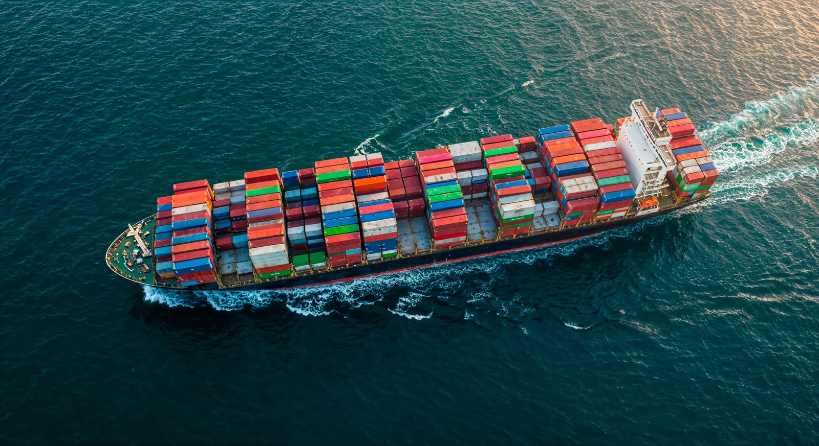 cargo-ship-carrying-shipping-containers-ocean-scaled